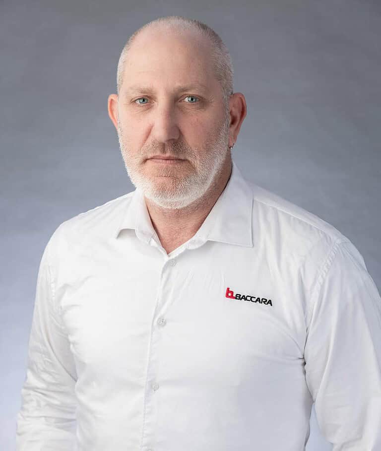 Industrial automation expert in white shirt with Baccara logo, focus on fluid control systems.